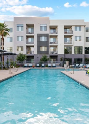 Outdoor pool with hot tub and lounge chairs