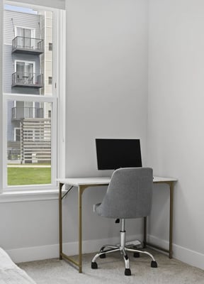 Dedicated desk with monitor and ergonomic chair